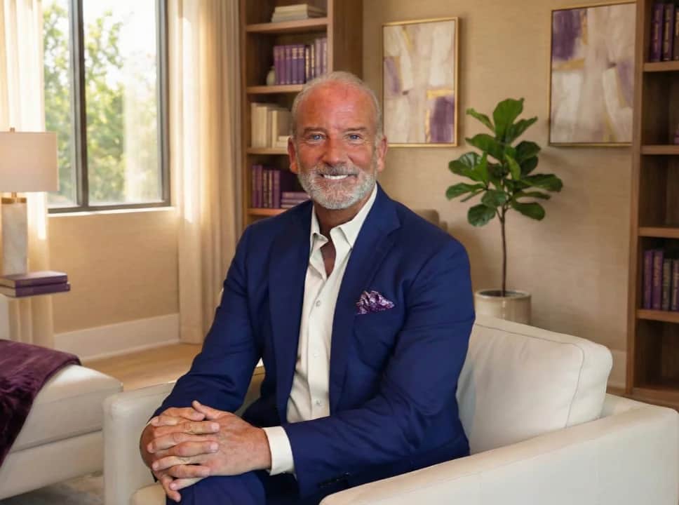 Kenny Weiss sitting in a chair in a modern office