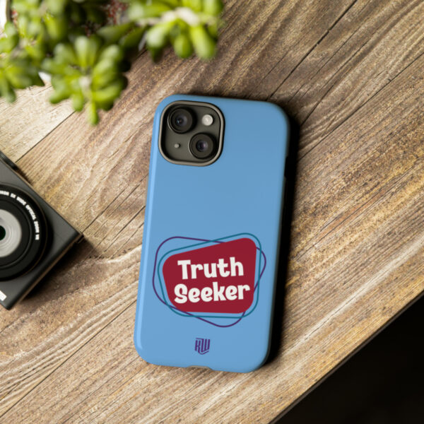 Truth Seeker Light Blue iPhone 15 Tough Case on table
